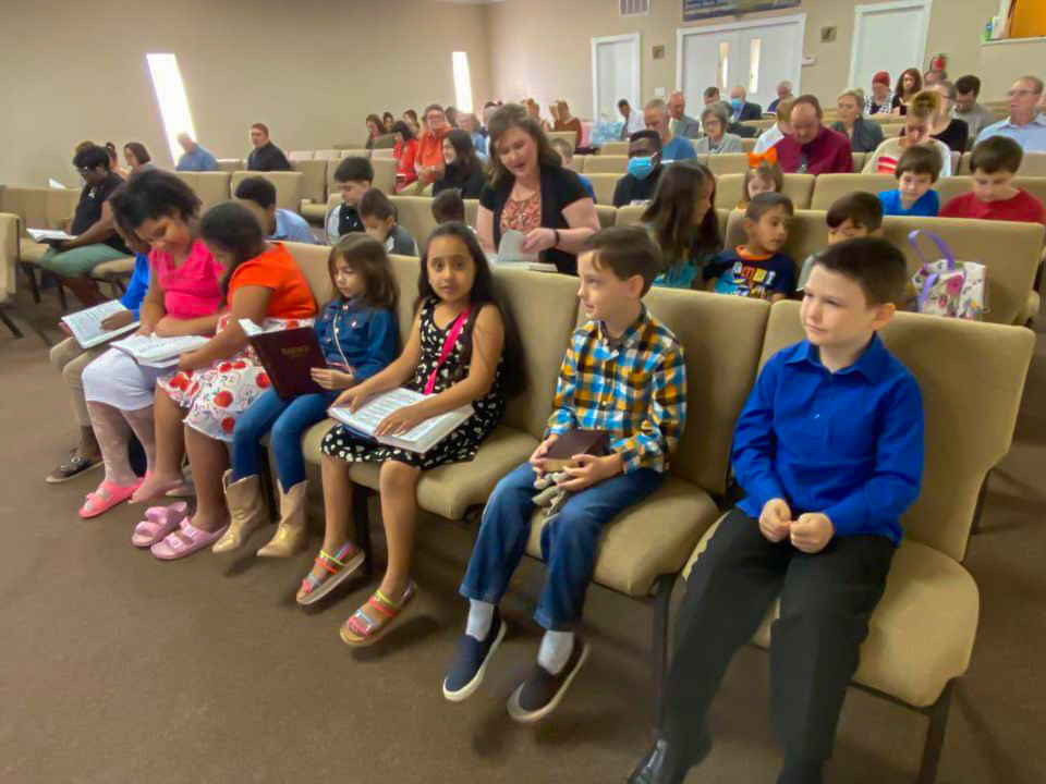 Children sitting in chairs during church service at Grandview Pines Baptist Church in Millbrook, Alabama